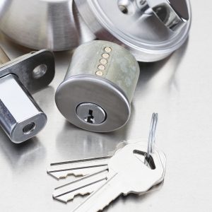 Silver door knob lock and keys on table